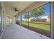 Screened-in patio with outdoor ceiling fan and a view of the landscaped backyard at 3565 Raleigh Dr, Winter Haven, FL 33884