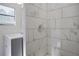 Modern bathroom featuring stylish marble-look tiles, vanity, and updated fixtures at 3611 Island Oaks Ct, Lakeland, FL 33805