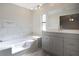 Bright bathroom with marble tile, new vanity, and modern fixtures at 3611 Island Oaks Ct, Lakeland, FL 33805
