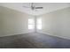 Carpeted bedroom with neutral paint, two windows and a ceiling fan at 3611 Island Oaks Ct, Lakeland, FL 33805