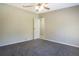 Neutral bedroom with fan, doorway and carpeting offers a cozy, blank slate at 3611 Island Oaks Ct, Lakeland, FL 33805