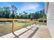 Wooden deck with railings offering an unobstructed view of the front yard and surrounding greenery at 3611 Island Oaks Ct, Lakeland, FL 33805