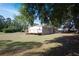 Home featuring spacious lawn, deck and shade trees at 3611 Island Oaks Ct, Lakeland, FL 33805