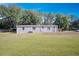 One-story house displaying neutral siding, complemented by a large, grassy yard at 3611 Island Oaks Ct, Lakeland, FL 33805