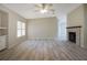Bright living room with ceiling fan, fireplace, and laminate wood flooring at 3611 Island Oaks Ct, Lakeland, FL 33805