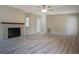 Open concept living room with brick fireplace, wood flooring, and neutral paint at 3611 Island Oaks Ct, Lakeland, FL 33805