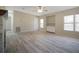 Open living room featuring wood-look flooring, a ceiling fan, built-ins and a fireplace at 3611 Island Oaks Ct, Lakeland, FL 33805