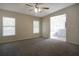 Bright main bedroom with ensuite bathroom, carpet and windows at 3611 Island Oaks Ct, Lakeland, FL 33805
