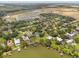Scenic aerial view of waterfront homes with private docks surrounded by verdant landscaping and a glimpse of a new community at 3826 Gaines Ct, Winter Haven, FL 33884