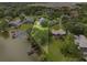 An aerial view of a home on a large lot with mature trees and waterfront access at 3826 Gaines Ct, Winter Haven, FL 33884