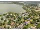 Expansive aerial view of the neighborhood showcasing lakefront properties with lush green landscaping at 3826 Gaines Ct, Winter Haven, FL 33884