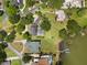 Spacious home with a private pool, surrounded by mature trees and a well-manicured lawn, complete with waterfront views and a dock at 3826 Gaines Ct, Winter Haven, FL 33884