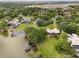 Drone shot of sprawling waterfront homes with docks and lush greenery along the shoreline, showcasing serene lakeside living at 3826 Gaines Ct, Winter Haven, FL 33884