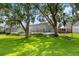 Backyard view of screen enclosed pool, boat, and nicely maintained green yard at 3826 Gaines Ct, Winter Haven, FL 33884