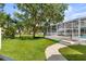 Expansive backyard with lush green lawn, screened-in lanai, and a glimpse of the waterfront view at 3826 Gaines Ct, Winter Haven, FL 33884