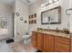 Bathroom with a granite countertop, wood cabinets, and tiled floors at 3826 Gaines Ct, Winter Haven, FL 33884