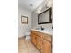 Bright bathroom featuring a wooden vanity with a white countertop and decorative lighting fixtures at 3826 Gaines Ct, Winter Haven, FL 33884
