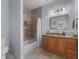 Well-lit bathroom features a vanity, shower with tile surround, and modern fixtures at 3826 Gaines Ct, Winter Haven, FL 33884