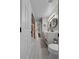 Bathroom with dual sinks, white vanity, and a view towards the hallway, providing a practical layout at 3826 Gaines Ct, Winter Haven, FL 33884