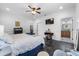 Comfortable bedroom featuring tile floors, ceiling fan, and en suite bathroom access at 3826 Gaines Ct, Winter Haven, FL 33884