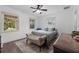 Bedroom featuring hardwood floors, two large windows, ceiling fan, and a comfortable bed at 3826 Gaines Ct, Winter Haven, FL 33884