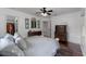 Well-lit bedroom with hardwood floors, large windows, ceiling fan, and ensuite access at 3826 Gaines Ct, Winter Haven, FL 33884
