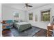 Cozy bedroom with a comfortable bed, three windows and ceiling fan at 3826 Gaines Ct, Winter Haven, FL 33884