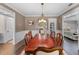 Elegant dining room featuring a chandelier, hardwood floors, and wainscoting at 3826 Gaines Ct, Winter Haven, FL 33884
