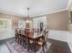 Bright dining room featuring wood floors, wainscoting, and a floral centerpiece at 3826 Gaines Ct, Winter Haven, FL 33884