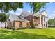 Well-maintained brick home with classic white columns and a beautifully landscaped yard at 3826 Gaines Ct, Winter Haven, FL 33884
