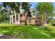 Brick home with white columns, manicured landscaping, and a lush green lawn at 3826 Gaines Ct, Winter Haven, FL 33884