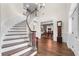 Stunning foyer showcasing a curved staircase, hardwood floors, and an inviting entryway into the dining room at 3826 Gaines Ct, Winter Haven, FL 33884