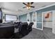 A home theater features comfortable leather seating, a large screen, and stylish decor for an immersive entertainment experience at 3826 Gaines Ct, Winter Haven, FL 33884