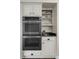 Gourmet kitchen featuring stainless steel ovens and custom white cabinetry at 3826 Gaines Ct, Winter Haven, FL 33884