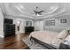This main bedroom offers hardwood floors, a tray ceiling, and an ensuite bathroom with and walk-in closets at 3826 Gaines Ct, Winter Haven, FL 33884