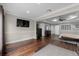 Spacious primary bedroom boasting hardwood floors, a tray ceiling, and an ensuite bathroom with dual walk-in closets at 3826 Gaines Ct, Winter Haven, FL 33884