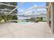 Resort-style pool with covered enclosure and serene views of nature at 3826 Gaines Ct, Winter Haven, FL 33884