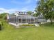 Screened-in pool area with white trim and a dark bottom, surrounded by green grass and manicured landscaping at 3826 Gaines Ct, Winter Haven, FL 33884