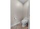 A modest powder room with a low-flow toilet and a tile floor offers basic functionality in a compact space at 3826 Gaines Ct, Winter Haven, FL 33884