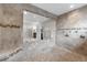 This custom walk-in shower includes dual shower heads, tiled bench and clear glass surround in an elegant bathroom at 3826 Gaines Ct, Winter Haven, FL 33884