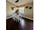 Charming dining room with dark wood floors and modern pendant lighting at 3851 Horizon View Loop, Lakeland, FL 33813