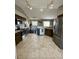 Open kitchen with stainless steel appliances, tile floors, and dark wood cabinets at 3851 Horizon View Loop, Lakeland, FL 33813