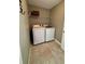 Functional laundry room with a washer, dryer, and convenient shelving at 3851 Horizon View Loop, Lakeland, FL 33813