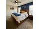 Comfortable bedroom with a king bed, navy accent wall, and neutral carpet at 3851 Horizon View Loop, Lakeland, FL 33813