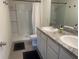 Bright bathroom featuring a walk-in shower, dual sinks, and granite countertops at 386 Feltrim Reserve Blvd # 386, Davenport, FL 33837