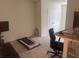 This bedroom includes an office space and treadmill for at-home exercise at 386 Feltrim Reserve Blvd # 386, Davenport, FL 33837