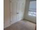 Bedroom with double door closet, neutral carpet and a window with blinds at 386 Feltrim Reserve Blvd # 386, Davenport, FL 33837