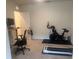 Versatile bonus room with exercise equipment and desk, perfect for a home gym or office at 386 Feltrim Reserve Blvd # 386, Davenport, FL 33837