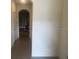 Inviting entryway with an arched doorway and neutral tile flooring offers a glimpse into the dining area at 386 Feltrim Reserve Blvd # 386, Davenport, FL 33837
