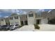 Townhome exteriors featuring attached garages, paved driveways, and manicured shrubbery create curb appeal at 386 Feltrim Reserve Blvd # 386, Davenport, FL 33837